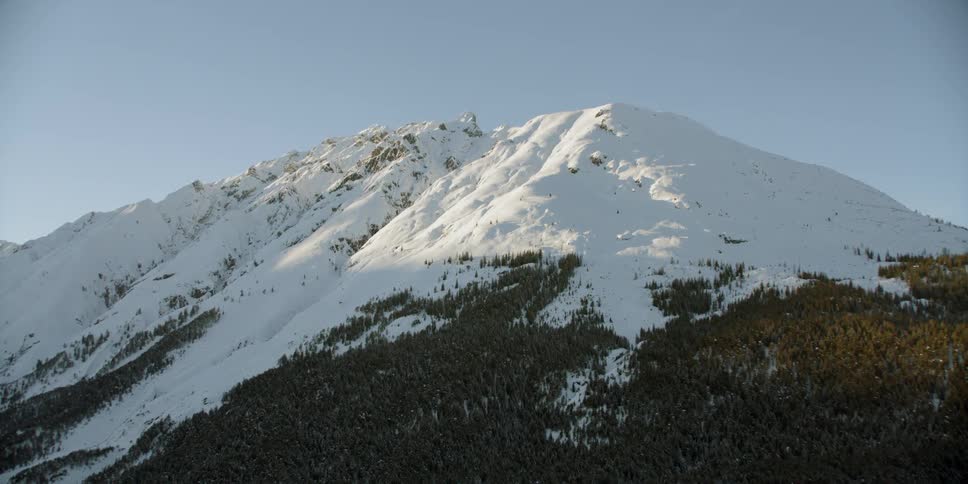 Snow covers the top of the mountain