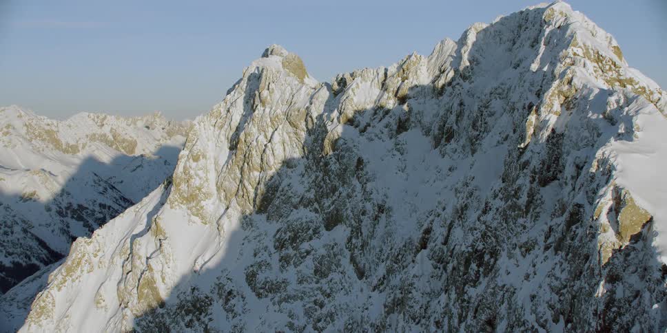 Snow covered rocky mountain ridge on a sunny day