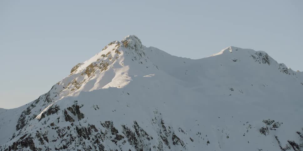 Snow covers the mountainous landscape