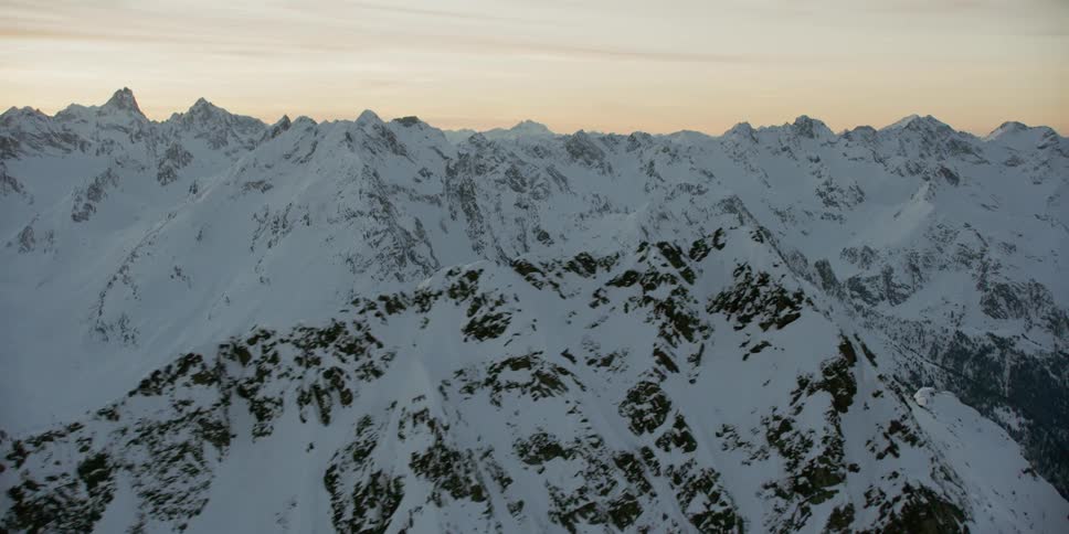 Snow covered peaks and ridges at sunset