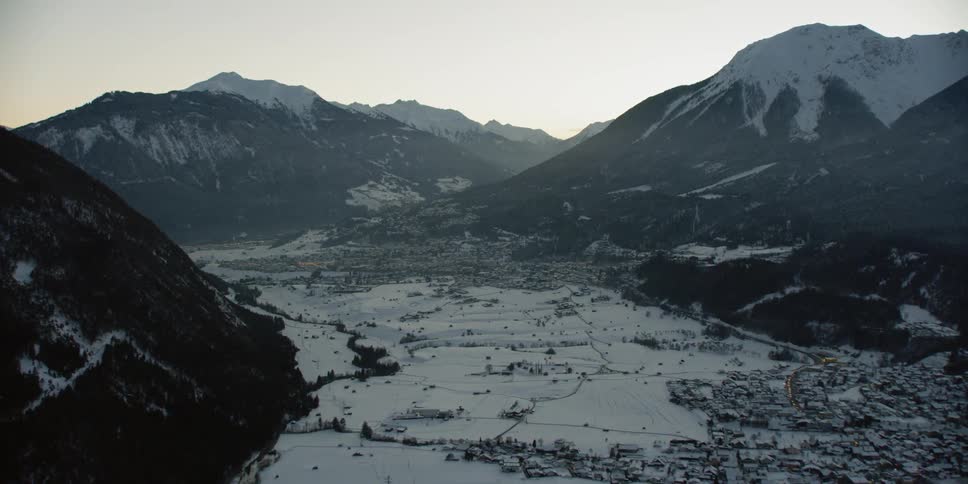 Snow and ice cover the landscape and mountains
