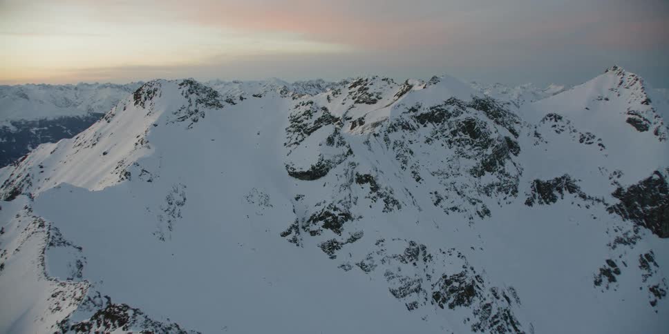 Snow covered ridges and slopes at sunset