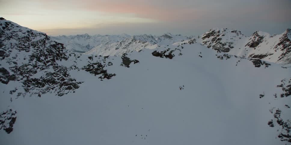 Snow covers the mountainous landscape