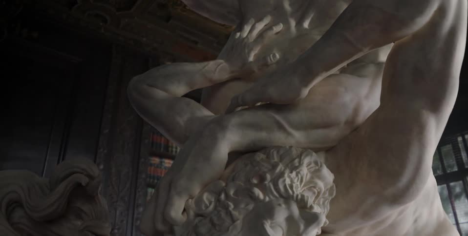Two statues inside a library room