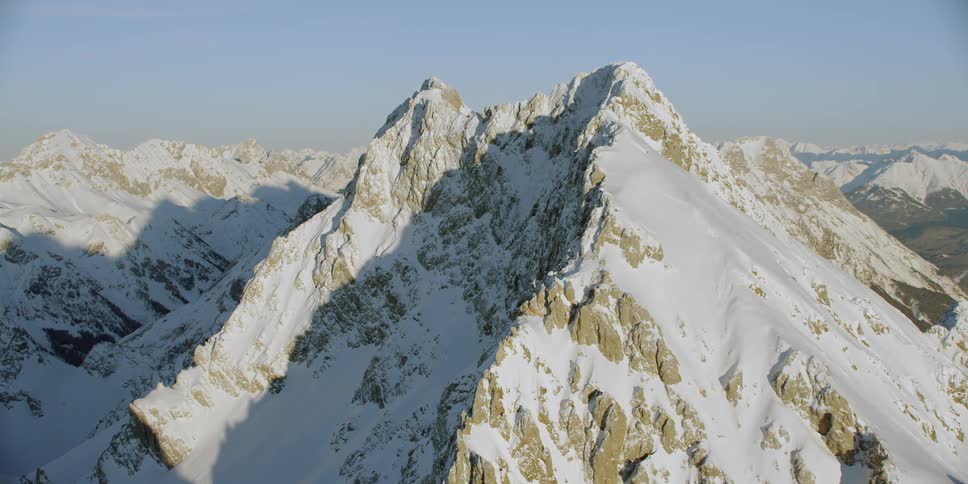 Snow covered mountains under a blue sky