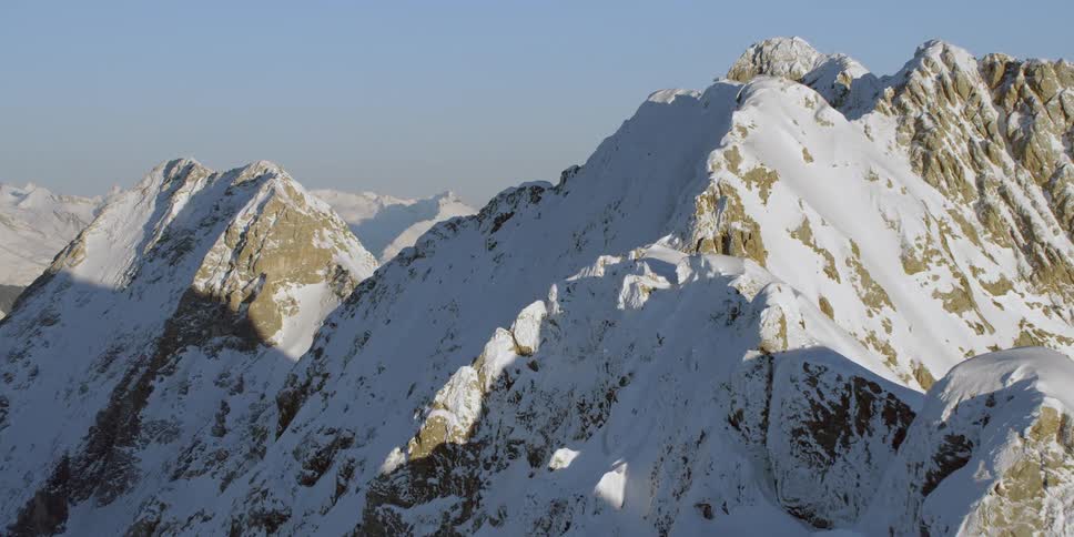 Snow covered mountains under a blue sky