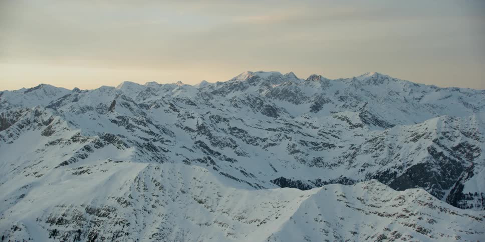 Sun rises over snowy mountains