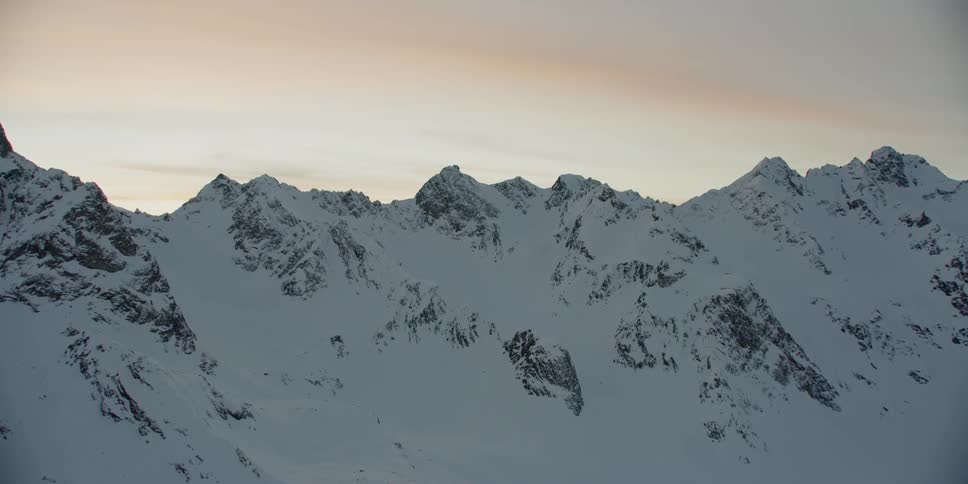 Snow covers the top of the mountain