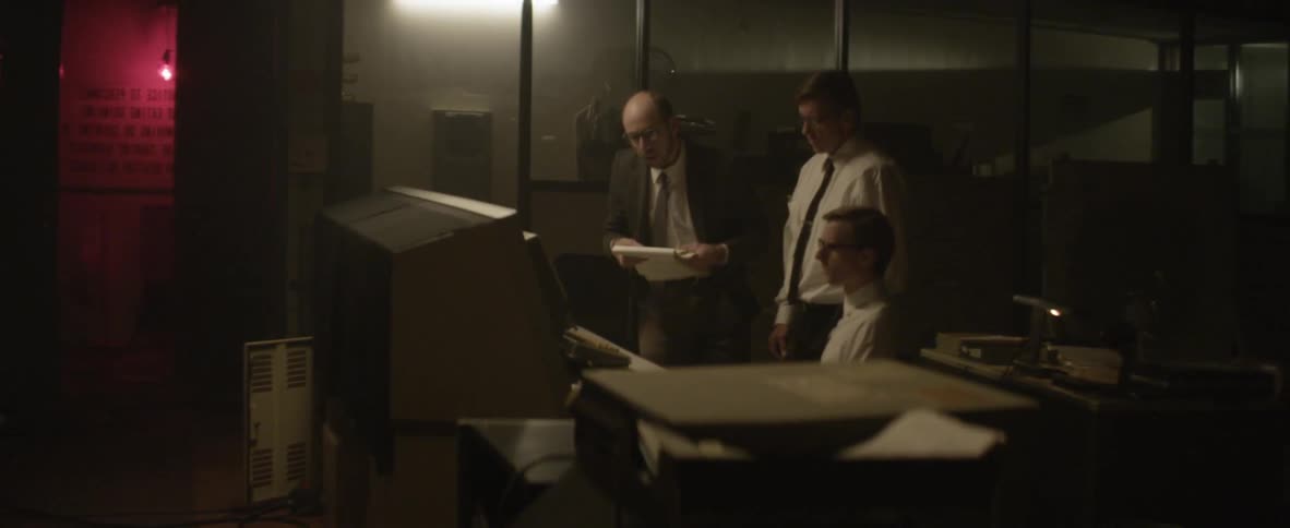Men work on old computers