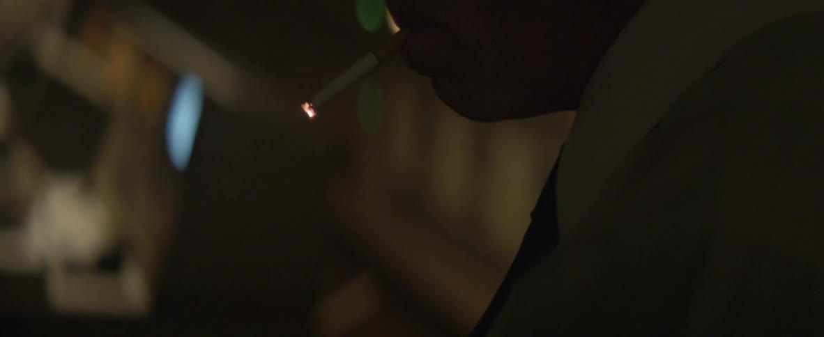 Man lights a cigarette with a match