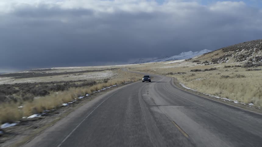 A car travels on a rural road