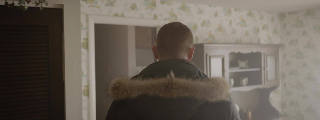 Man walks through a kitchen and dining room