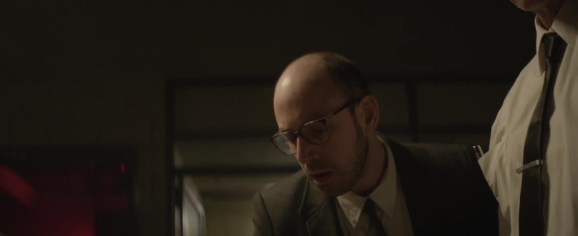 A man is leaning forward looking at something
