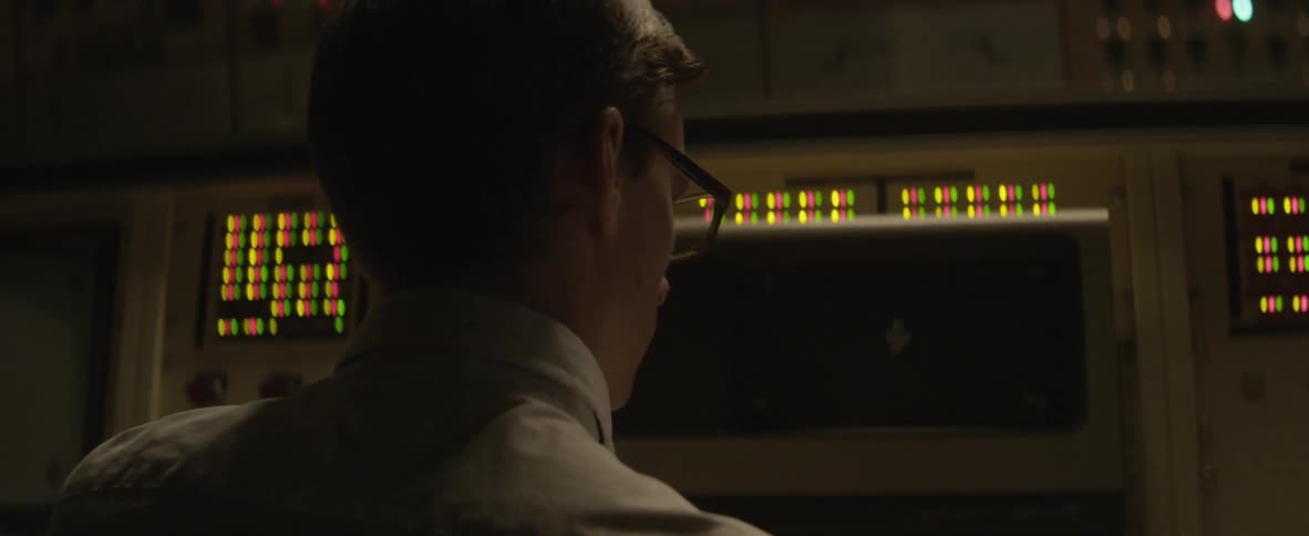 Man standing before a control panel