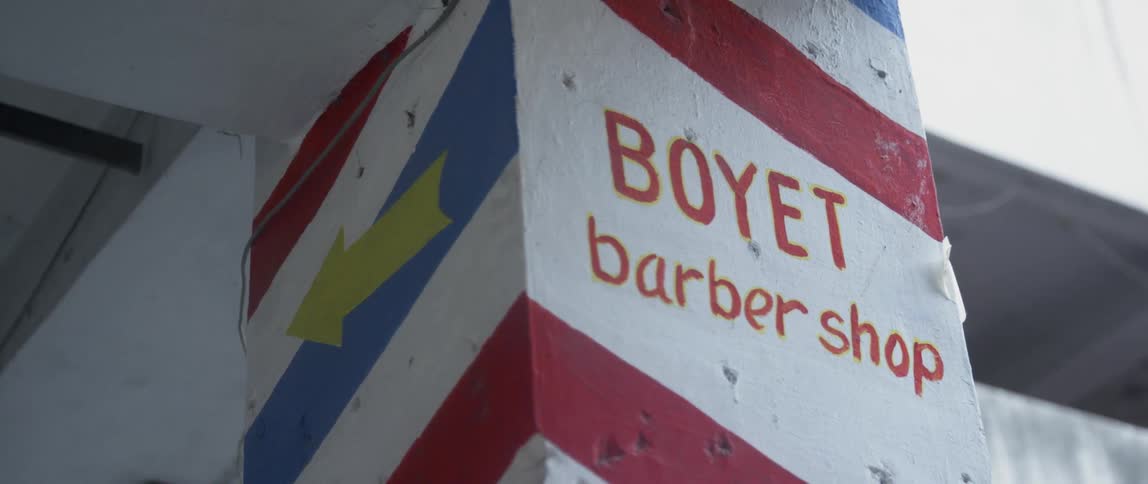 A barbershop sign is painted on a building