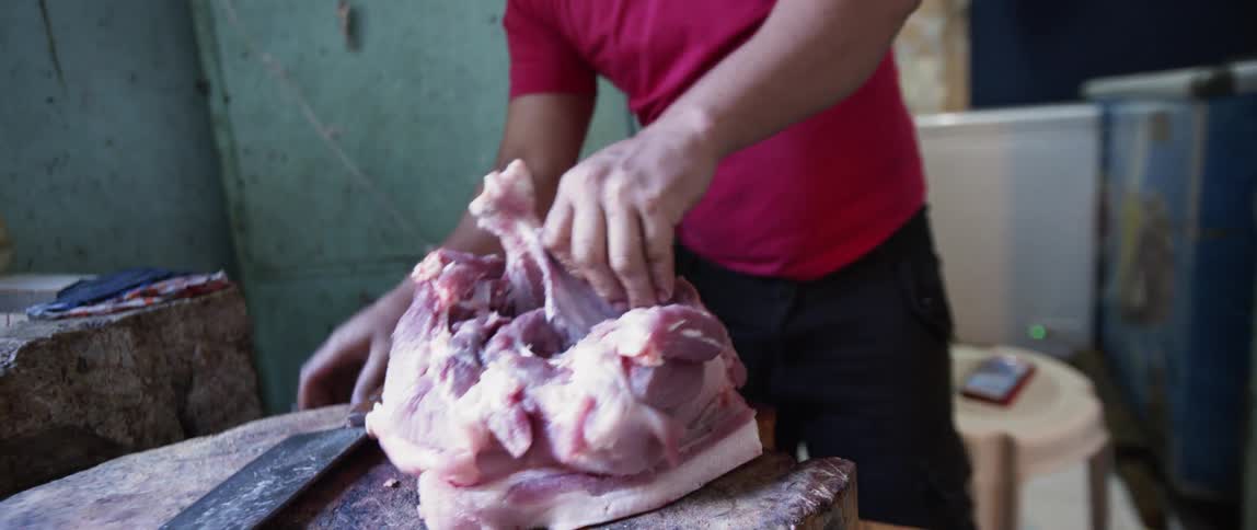 Man butchers a piece of meat