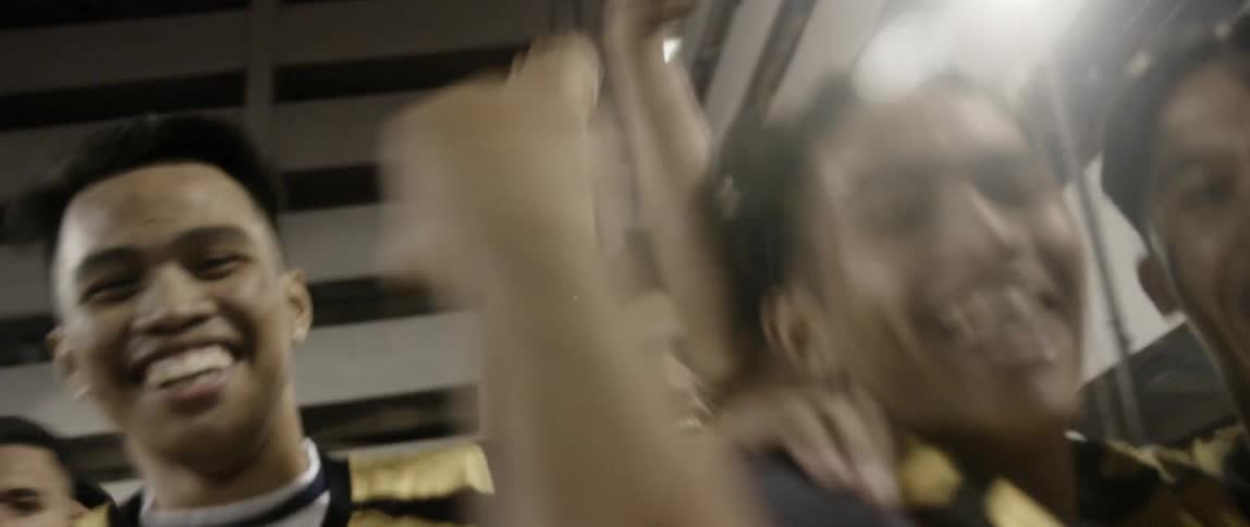 A basketball team smiles and dances