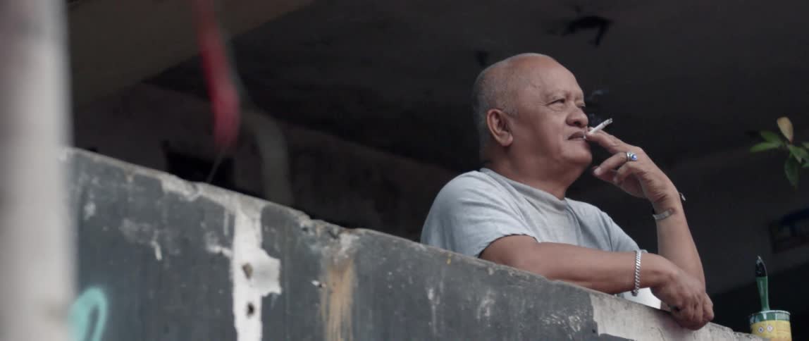 Man smokes a cigarette outside
