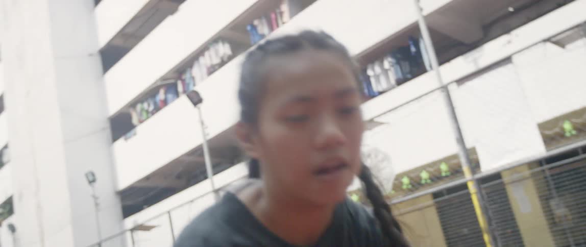 A girl shoots the basketball on the court