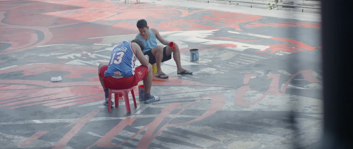 Two men paint on the rooftop