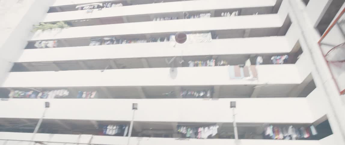 A girl throws a basketball and scores