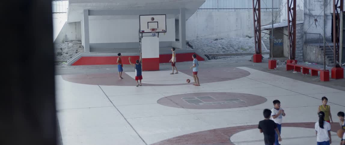 Men play basketball on a basketball court
