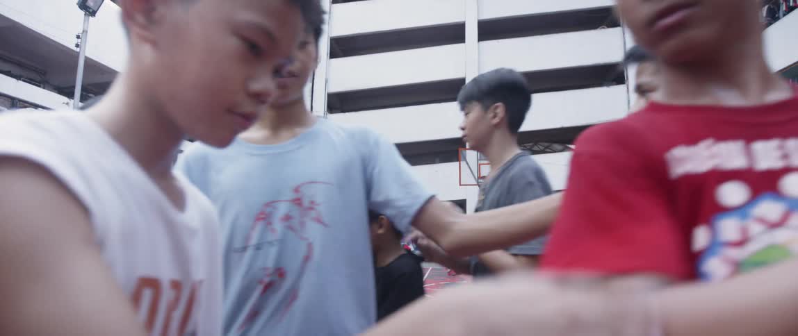 Boys pat each other on the back on a basketball court