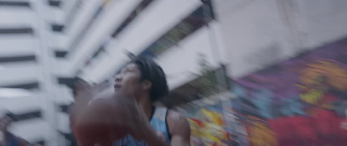 People play basketball on an outdoor basketball court