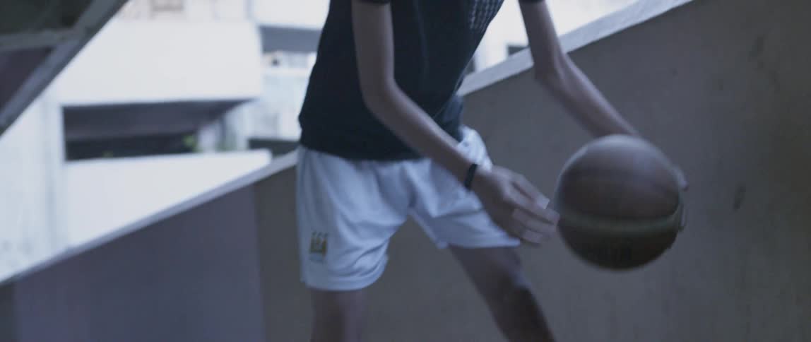 A young boy dribbles a basketball