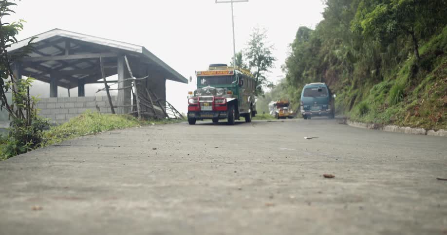 Vehicles travel on a rural road