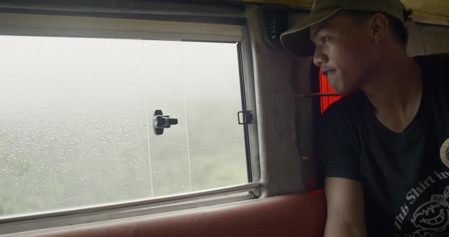 Man riding in van looks out window