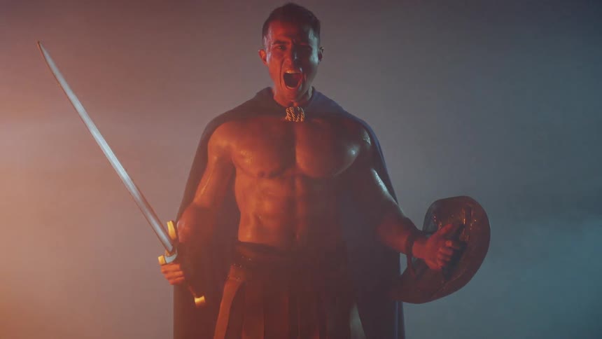 A man screams while holding a sword and shield