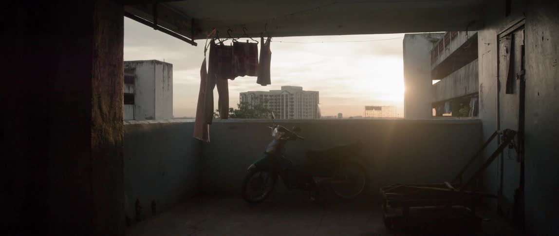 Clothes hang on a line in a large concrete building