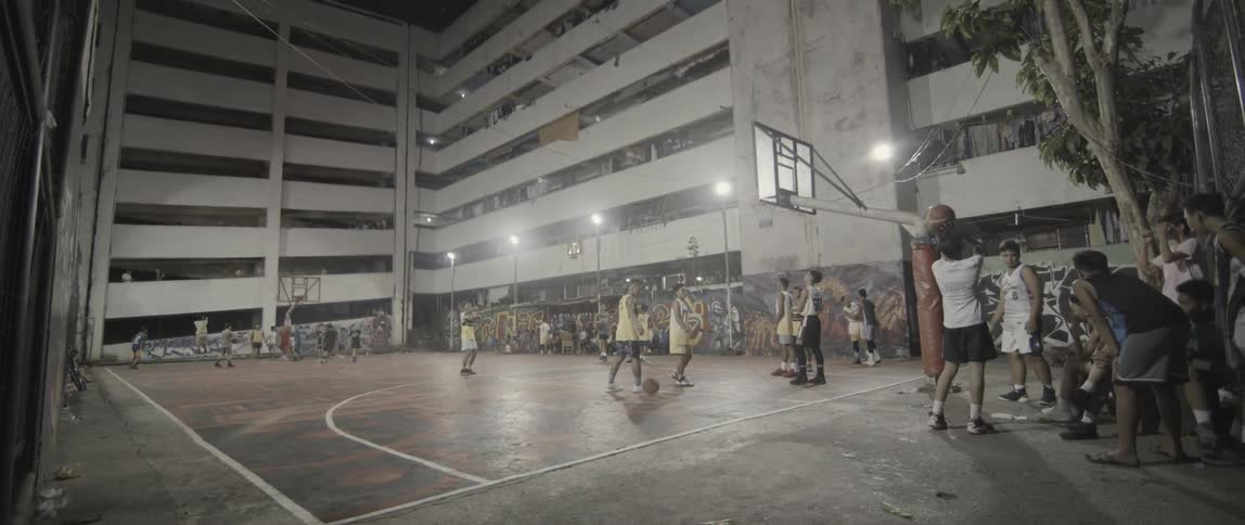 The children are playing basketball on the court