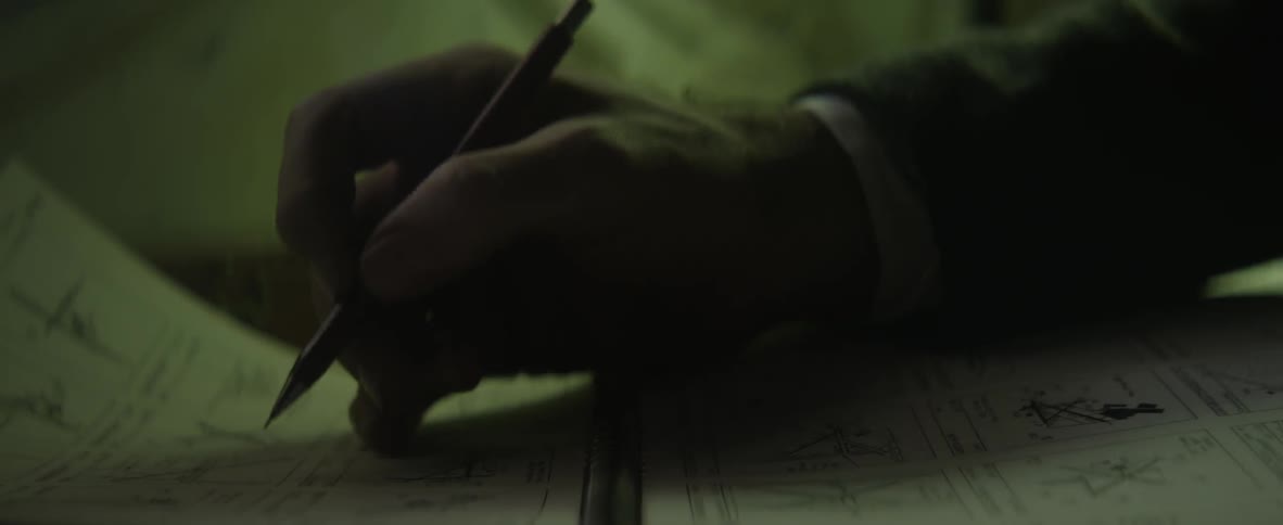 Person writing on a piece of paper