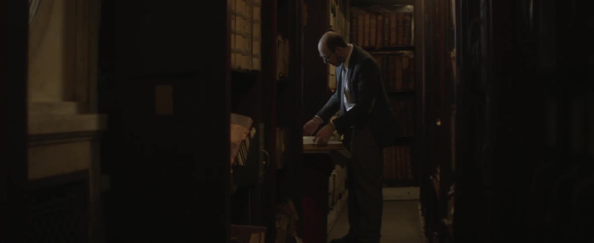 A man browsing a book in a library