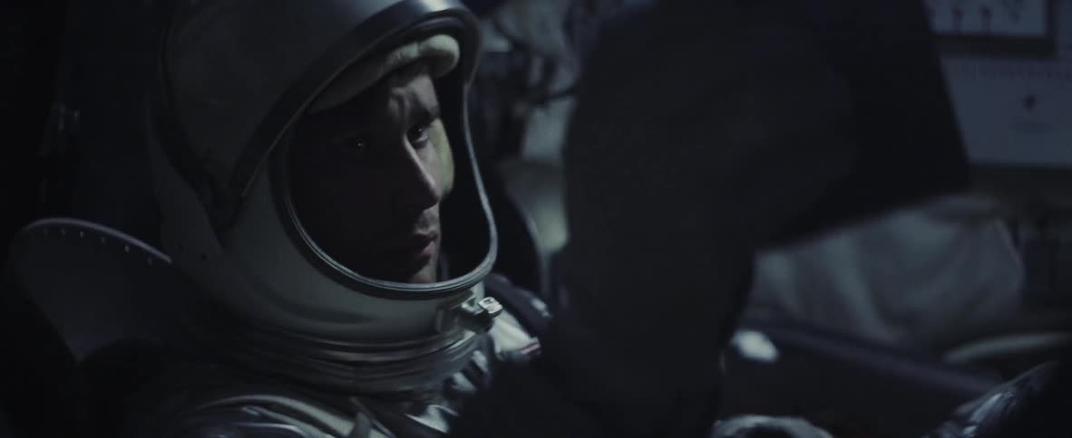 An astronaut sits in a spacecraft