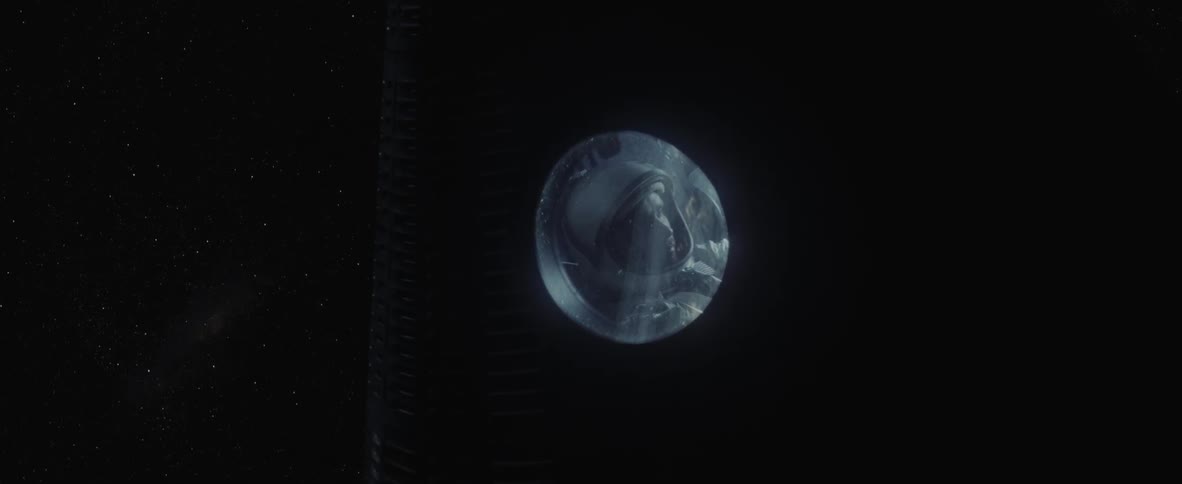 An astronaut's face is visible in the round window of the spaceship