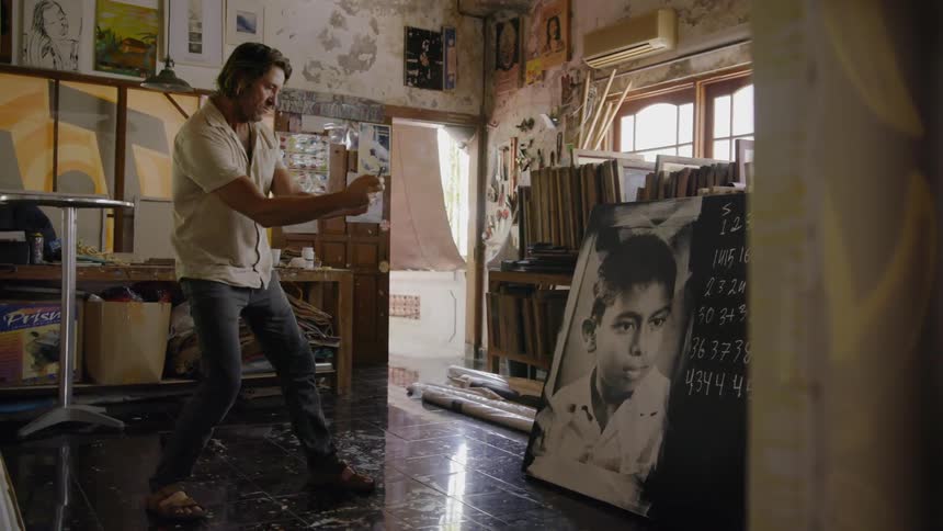 A man is photographing a portrait in a studio