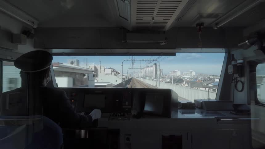 A train conductor directs the train