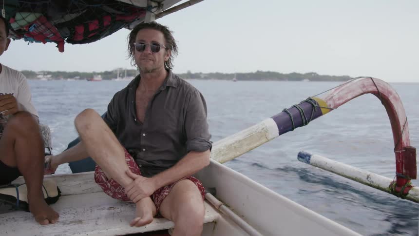 Two men ride in a boat