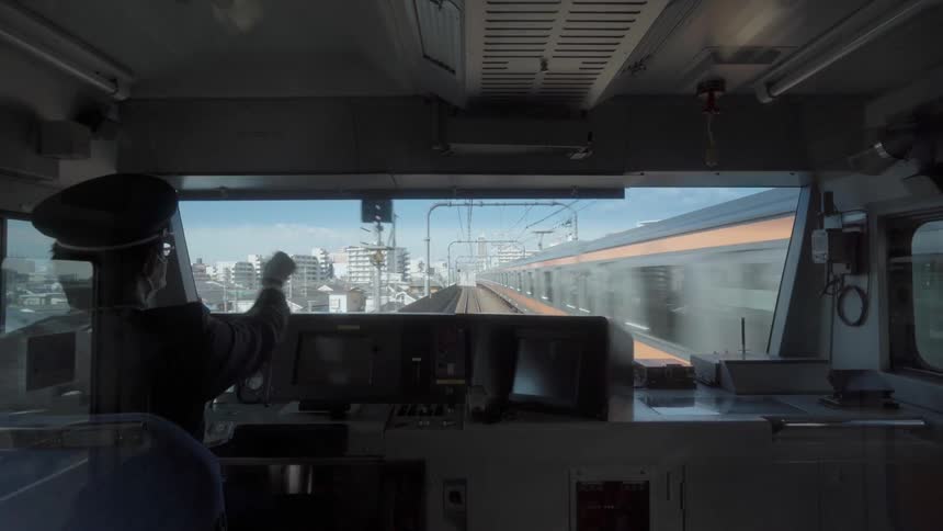 Man drives a train down the track