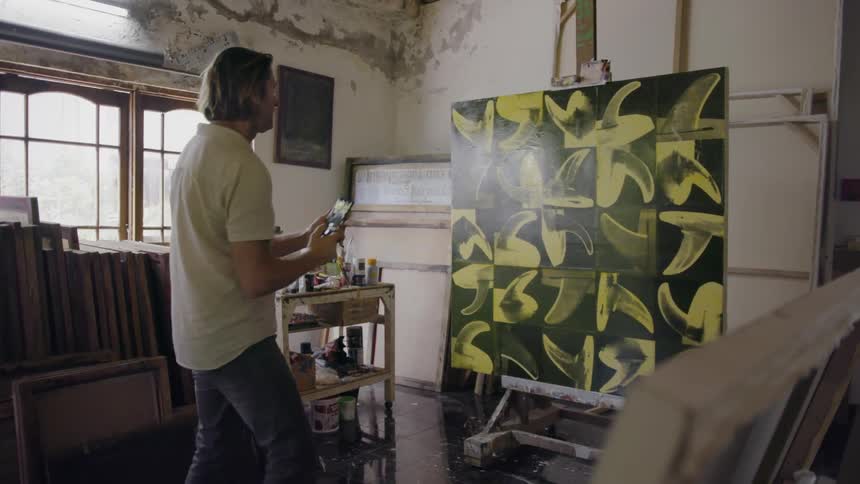 Man takes a picture of a piece of artwork