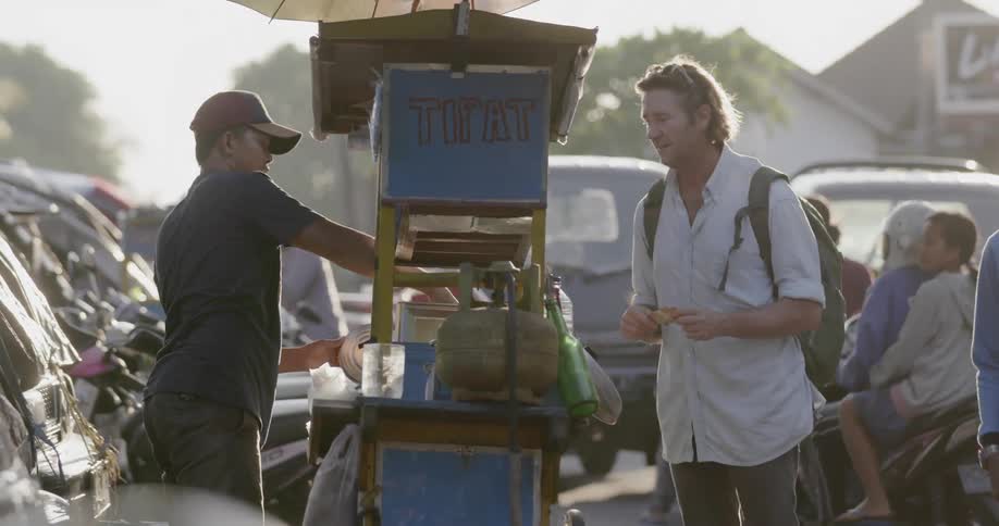 A man shops at a street vendors shop