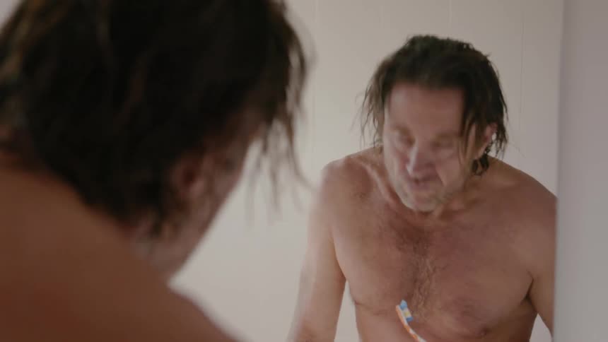 A man brushes his teeth