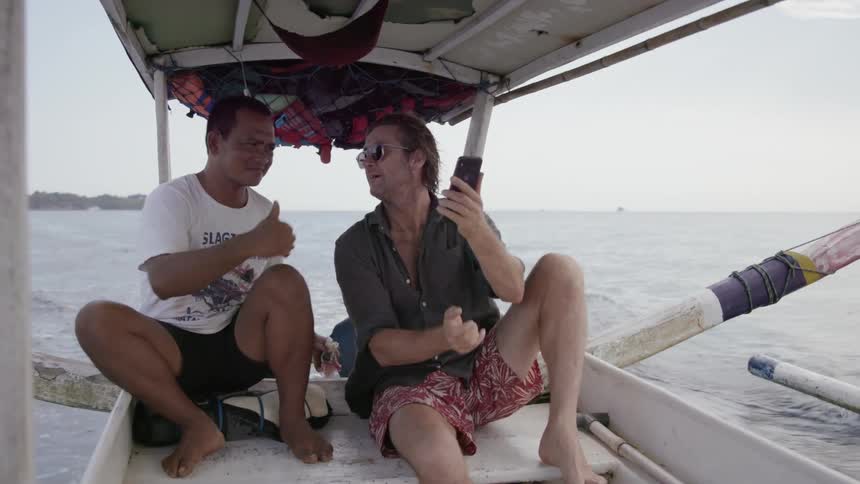 Two men ride on a boat