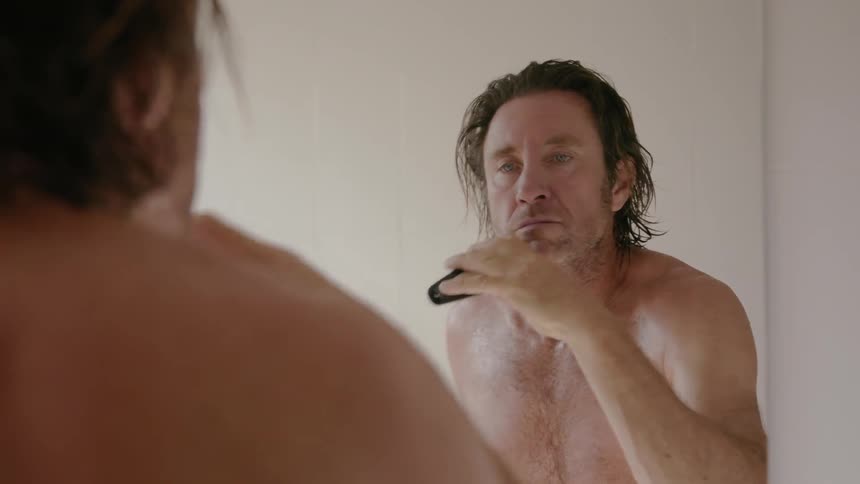A man shaves his beard