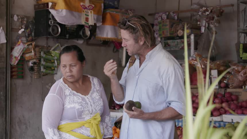 Man tries fruit at a market
