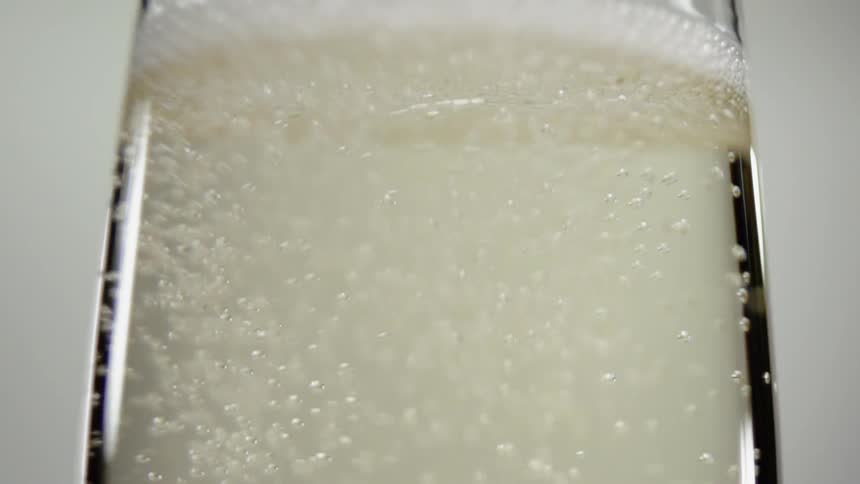 Bubbles from champagne rise to the top of the glass