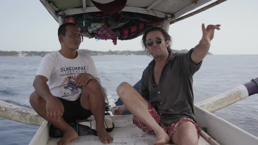 Two men ride in a small boat